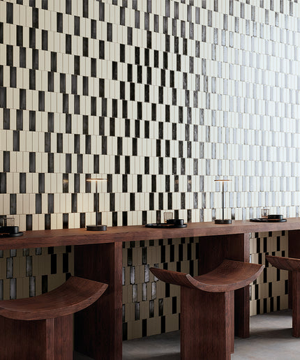 Modern interior with a patterned wall and wooden furniture.