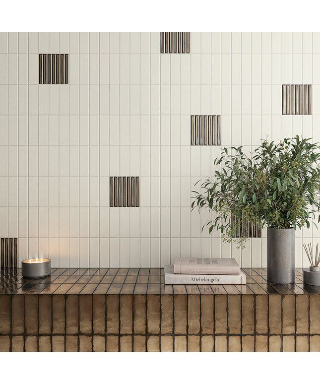 Modern interior design with green tiles, a wooden shelf, and decorative elements.