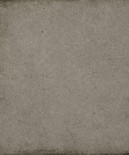 A square gray textured tile or panel with a distressed, concrete-like finish and darker worn edges.