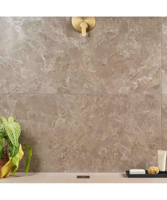 Tile wall with a shower head and decorative elements