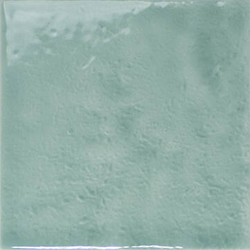 A square glossy ceramic tile in a light mint green or seafoam color, showing a subtle textured glaze finish.
