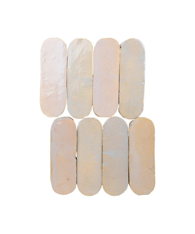 Glossy oval beige ceramic tiles arranged in two rows, perfect for backsplash or bathroom decor.