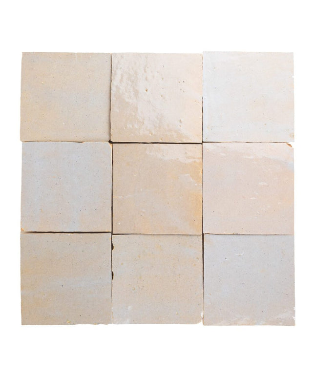 Glossy beige 4x4 zellige tiles with subtle handmade texture, perfect for kitchen backsplash or bathroom walls.
