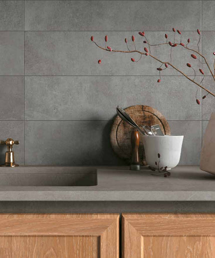 Matte gray wall tiles in modern kitchen backsplash with wood cabinets and decor
