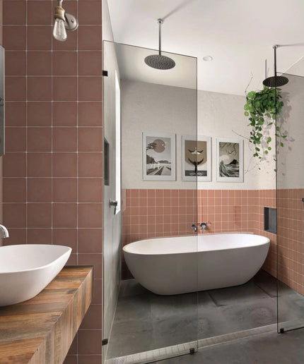 Modern bathroom with matte peach square wall tiles, freestanding tub, glass shower, vessel sinks