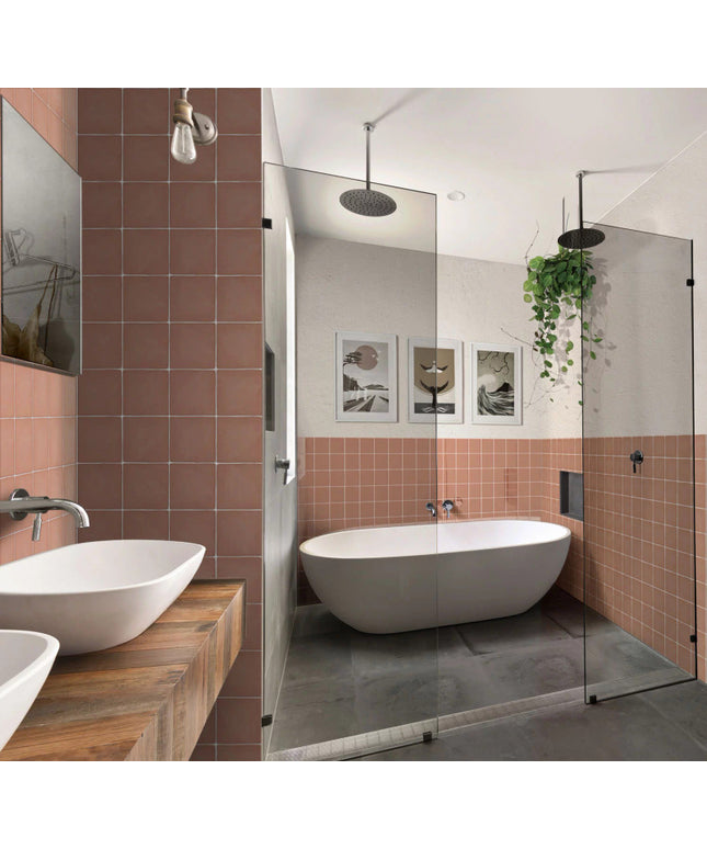 Modern bathroom with matte peach square wall tiles, freestanding tub, glass shower, vessel sinks