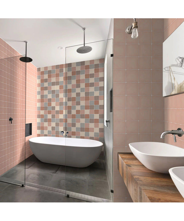 Modern bathroom with pink and beige square tiles, freestanding tub, and double sinks