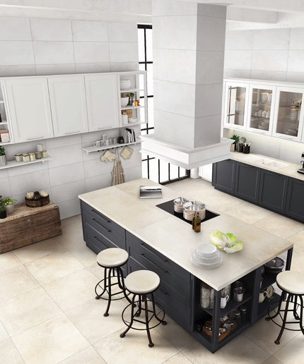 Modern kitchen with a central island, stools, and white tiled walls.