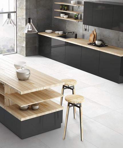 Modern kitchen with black cabinets, wooden countertops, and stools.