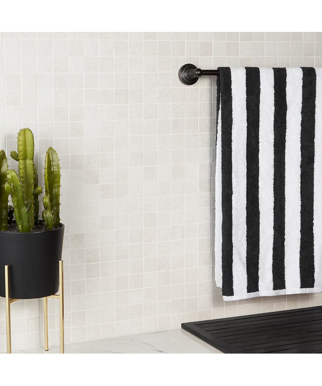 Black and white striped towel hanging on a rack next to a potted cactus in a bathroom. made in the USA