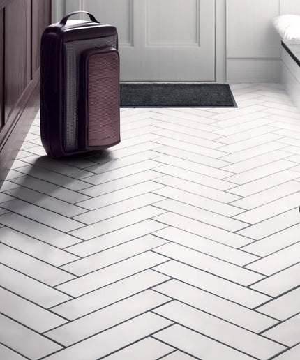 Modern interior with a suitcase on a white herringbone tile floor