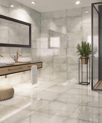 Modern bathroom with marble tiles, a sink, and a mirror.