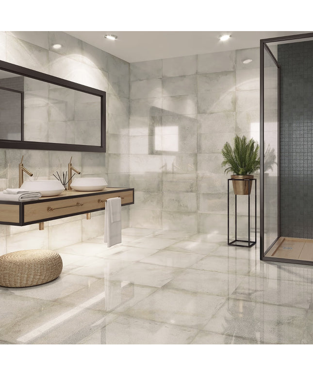 Modern bathroom with marble tiles, a sink, and a mirror.