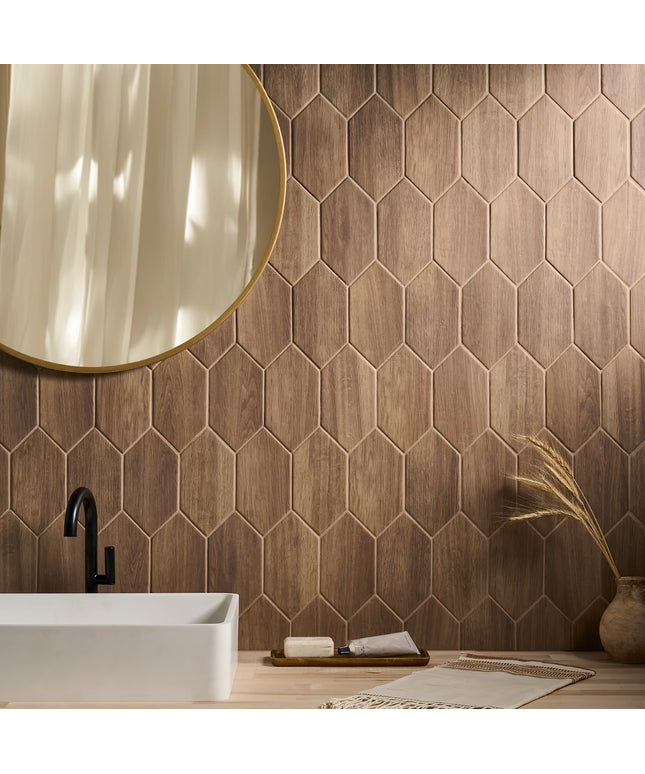 Bathroom with hexagonal wooden tiles, a white sink, and a round mirror.