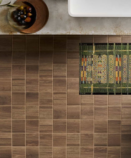 Decorative rug with geometric pattern on a tiled floor